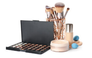 Set of makeup products and accessories on white background